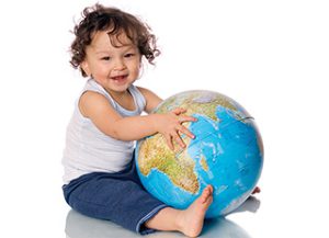 Happy baby with globe,isolated on a white background.